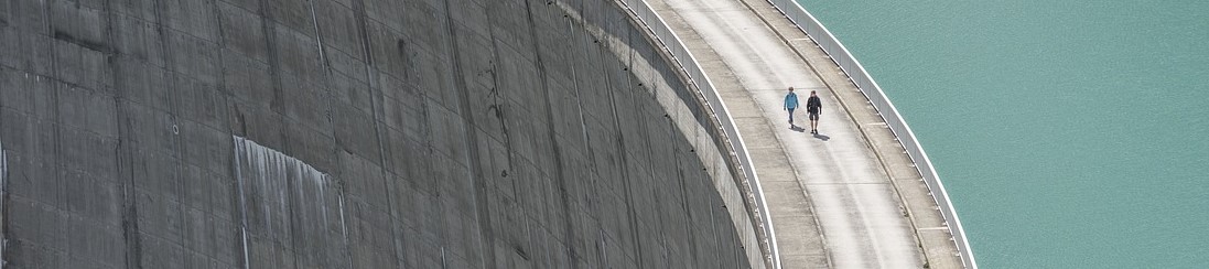 people walking on a huge hydropower plant